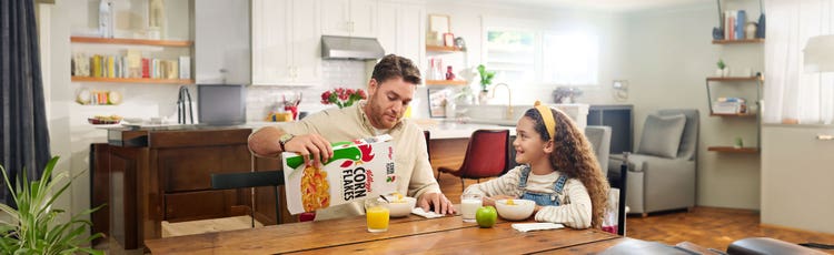 A father and daughter enjoying breakfast together.