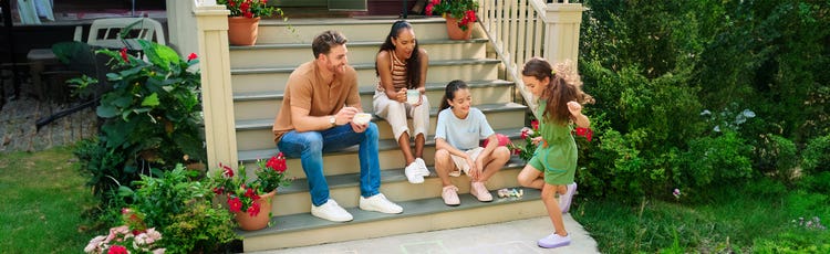A family sitting on their front steps.