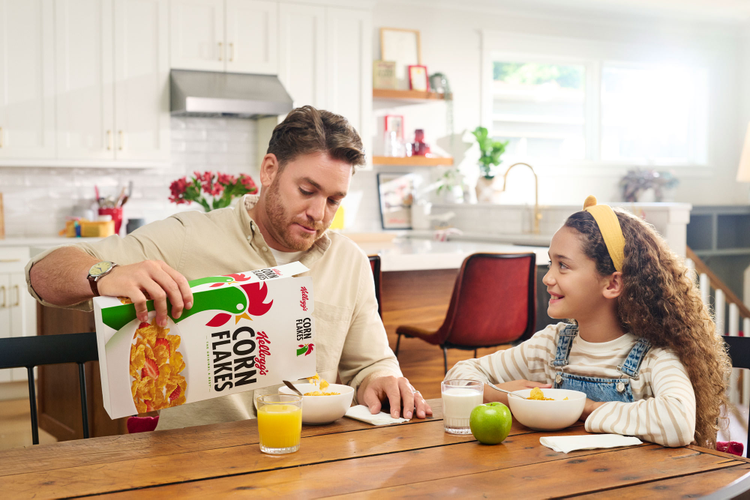 A father and daughter enjoying breakfast together.